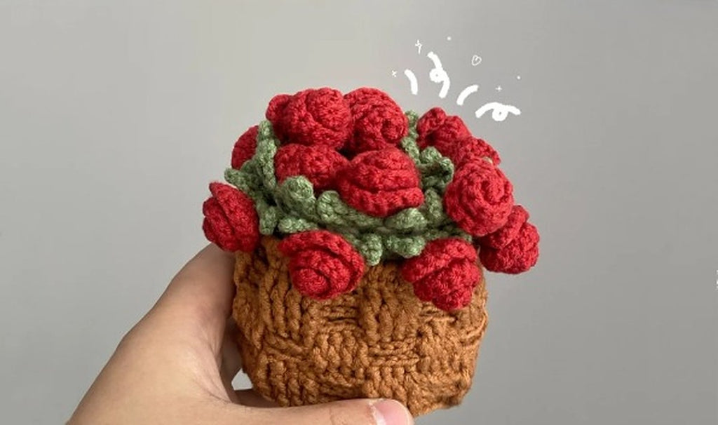 Crochet basket filled with red rolled roses and green leaves